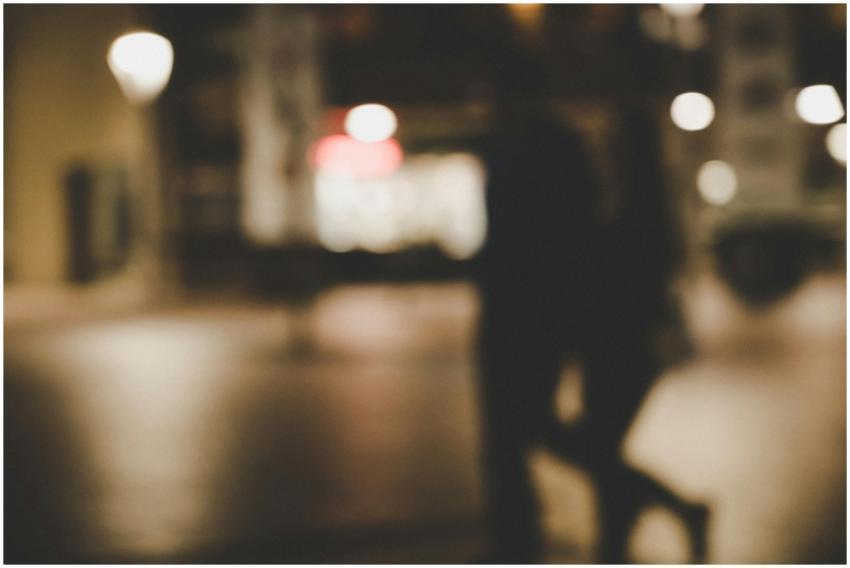 Out-of-focus image of a couple walking at night wi