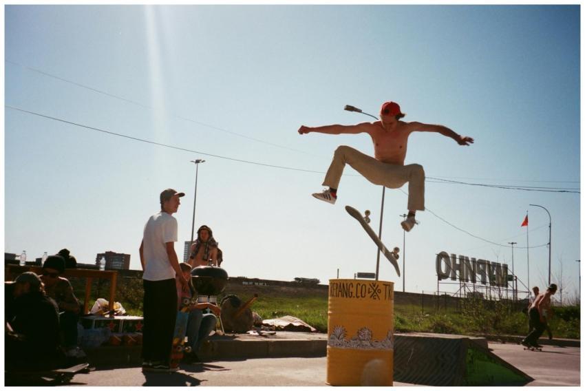 Energetic skateboarder performing a jump trick in