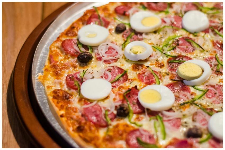 Savor a close-up of pizza topped with pepperoni, e