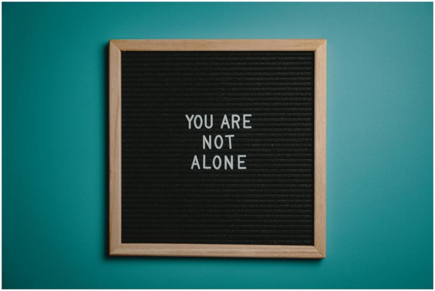 A wooden letter board displays a motivational mess