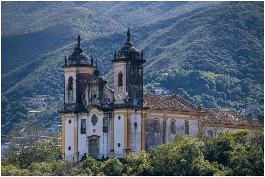 Baroque church set against a mountainous backdrop,