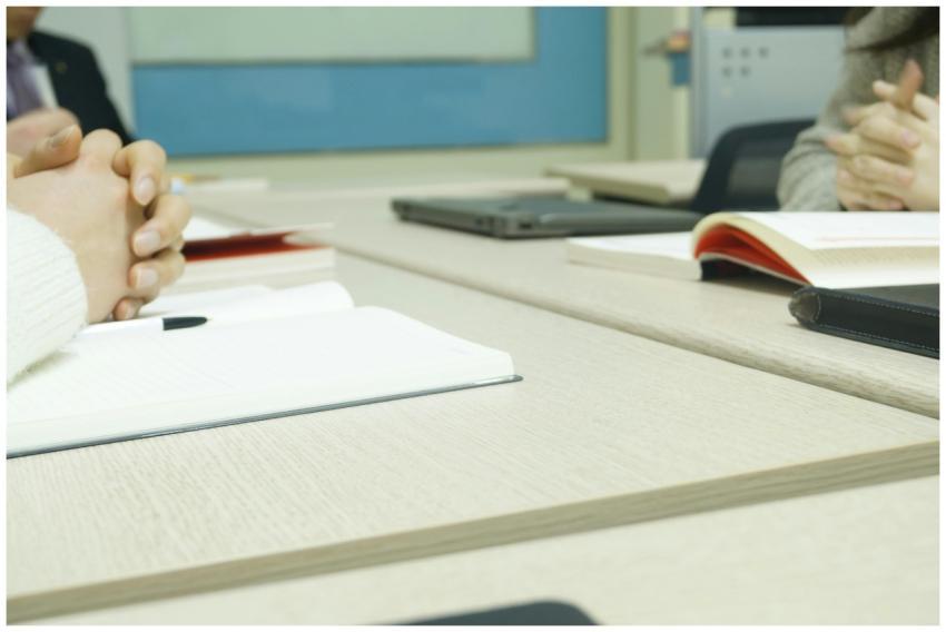 Close-up of a professional meeting setup with hand