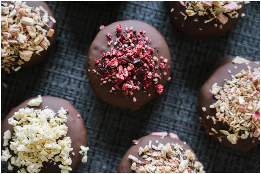 A top-down view of chocolate bites topped with var