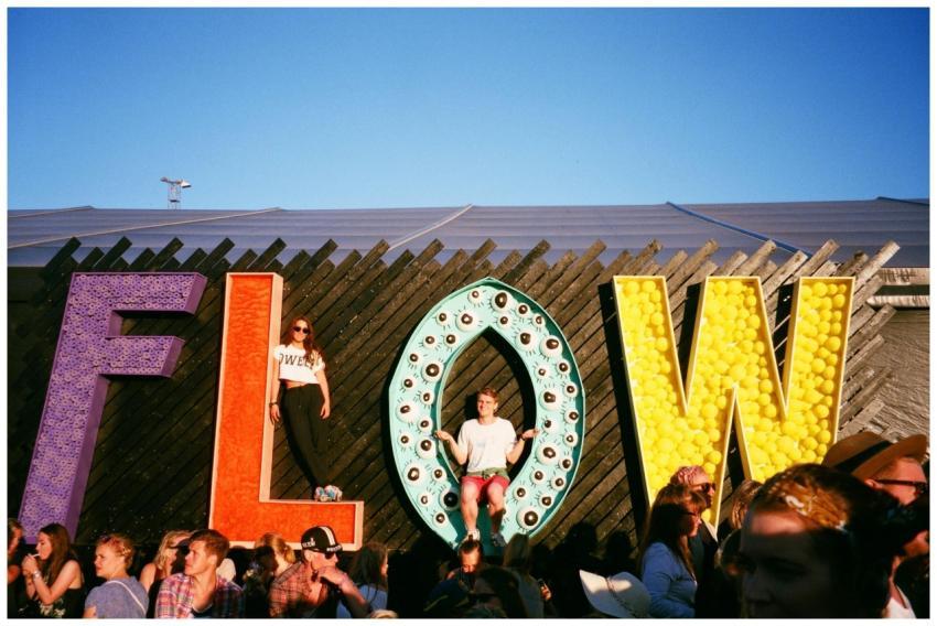 People enjoying a lively festival with colorful FL