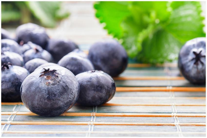 Close-up of fresh blueberries on a bamboo surface