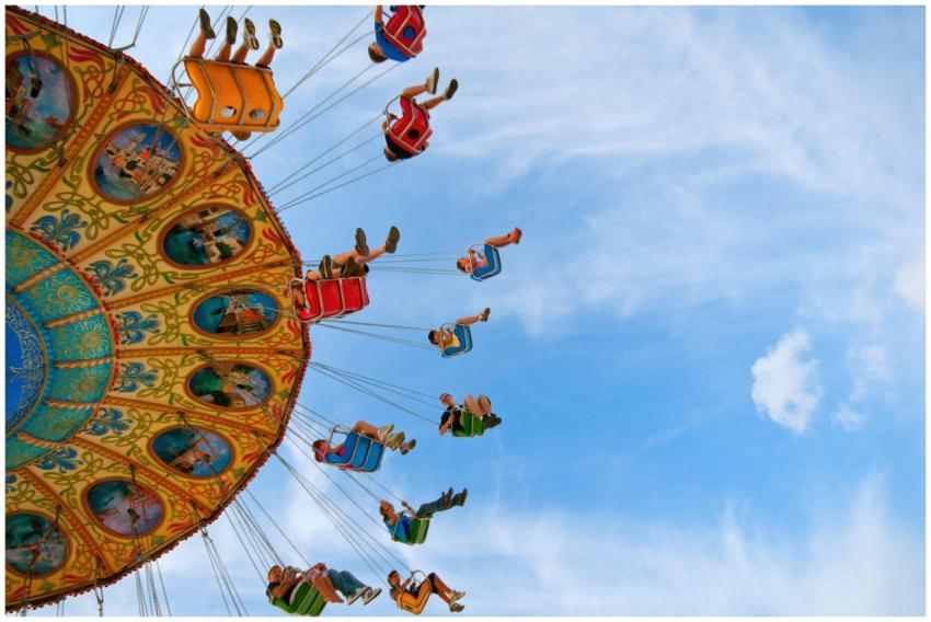 Colorful swing ride at an amusement park with peop