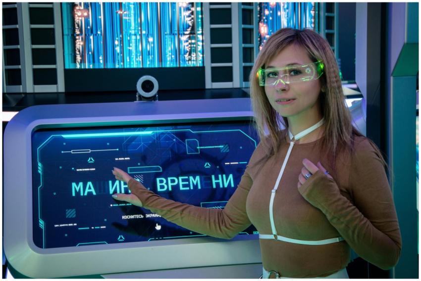 A woman interacts with a futuristic touchscreen di