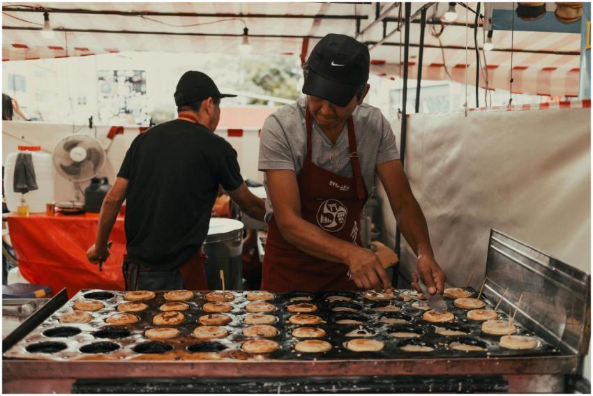 Asian street food vendor preparing snacks outdoors