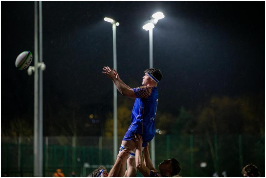 Rugby players in an action-packed lineout under fl