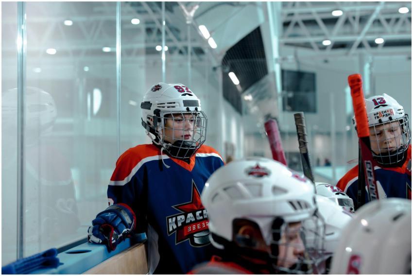 Youth hockey team players gather in the rink durin