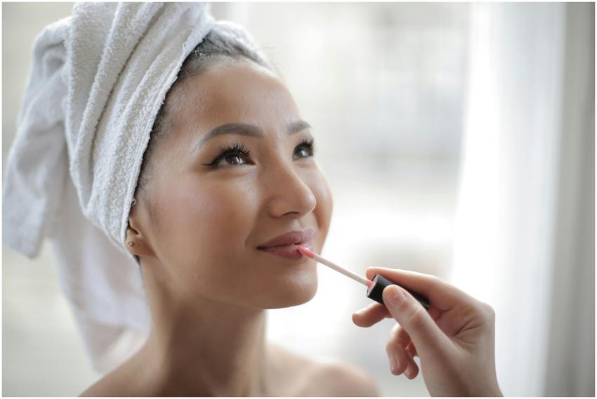 Young woman indoors enjoying skincare routine whil