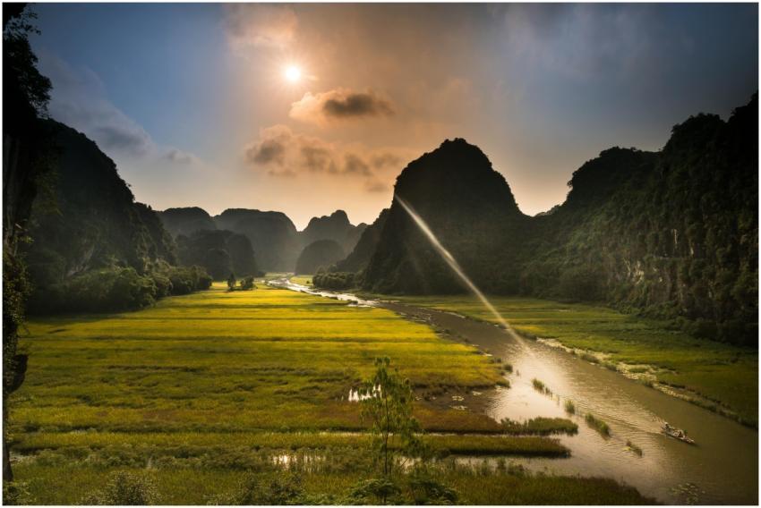 Stunning sunset view over rice fields and river in
