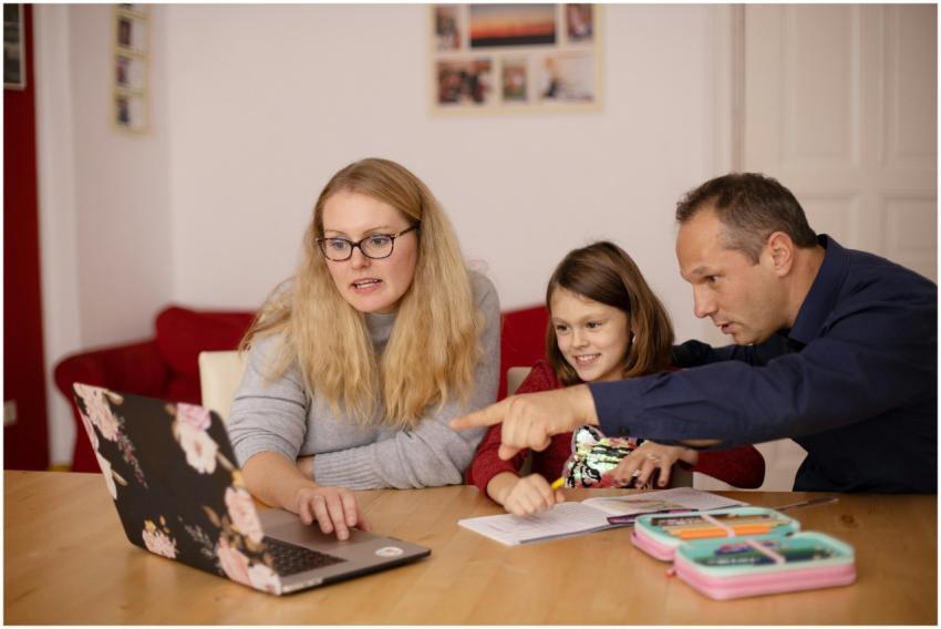 A family learning together with a laptop at home,