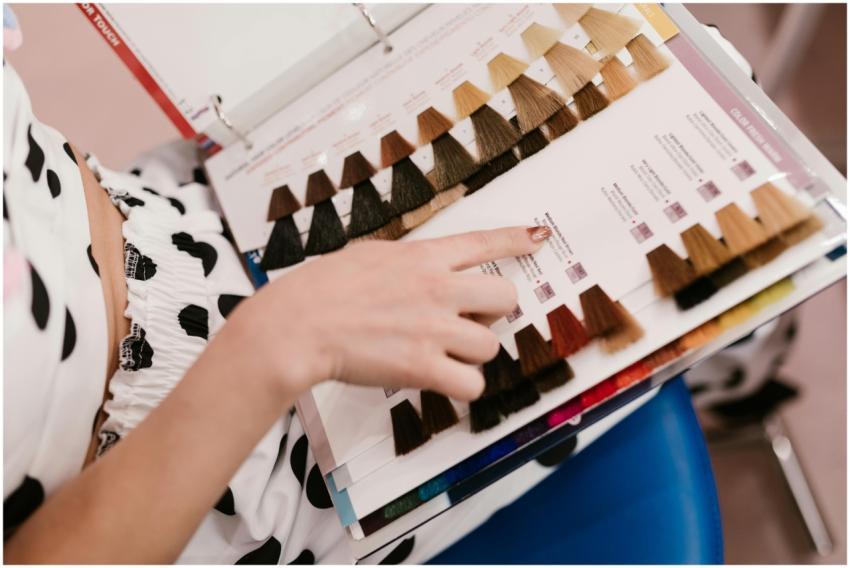 Woman selecting hair color samples in a salon, sho
