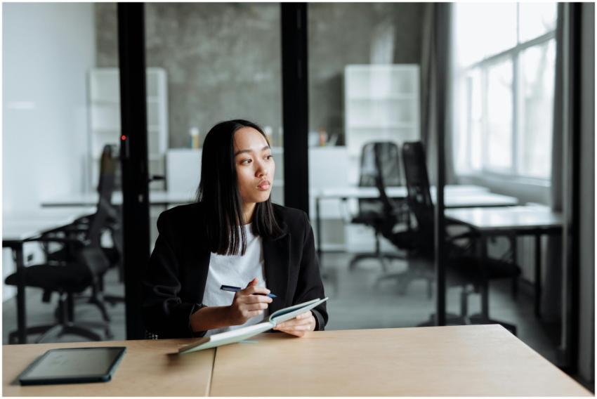 Portrait of a woman in a modern office pondering i