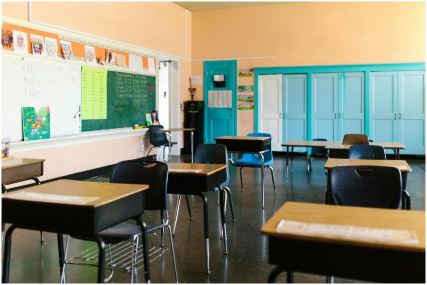 Bright and colorful empty classroom with desks, bl