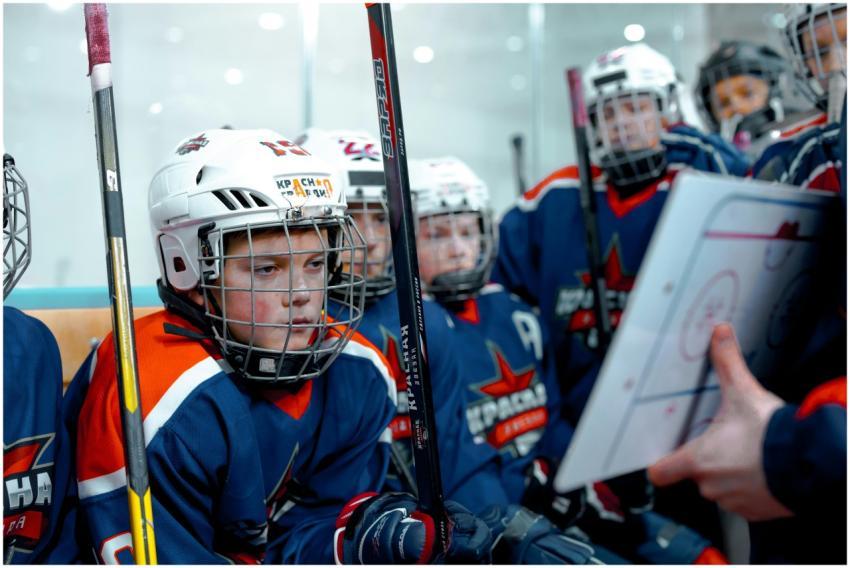 Young hockey players listen to coach's strategy du
