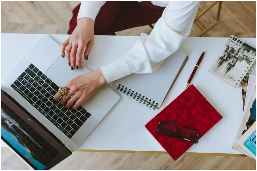Overhead view of a workspace featuring a laptop, n
