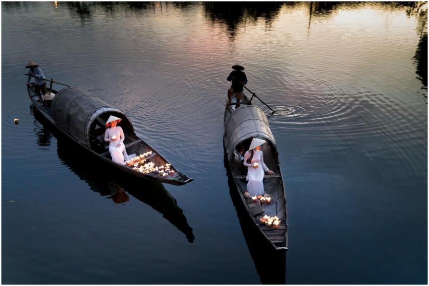 Serene river scene with traditional boats and glow