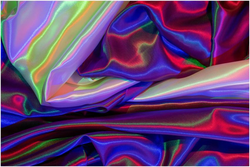 A close-up of vibrant satin fabric displaying colo