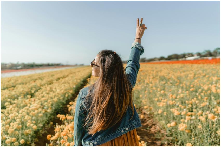 A woman enjoying a sunny day in a vivid yellow flo