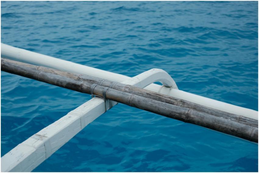 A serene scene featuring a wooden outrigger on a v