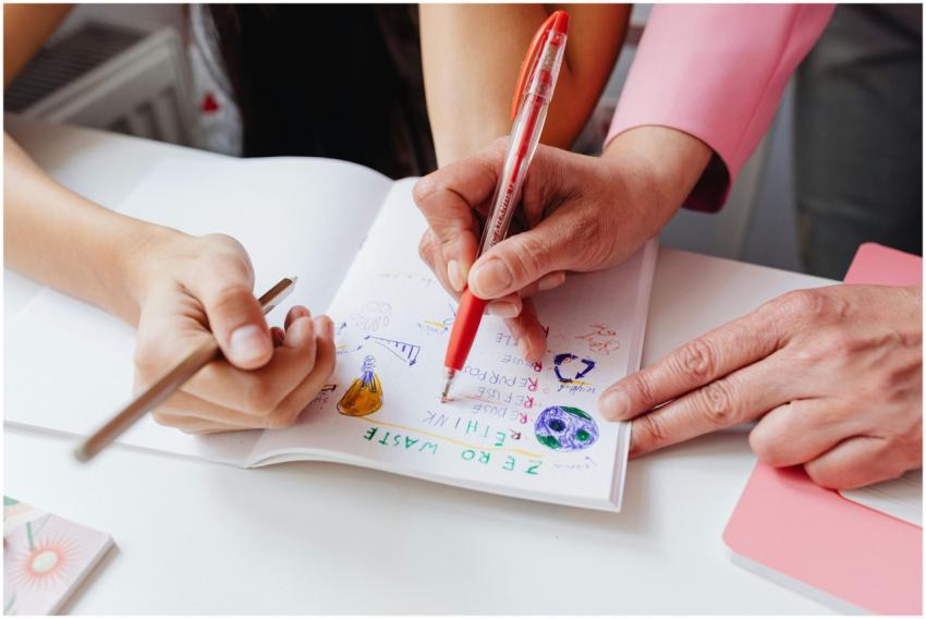 Teacher and student working together on colorful h