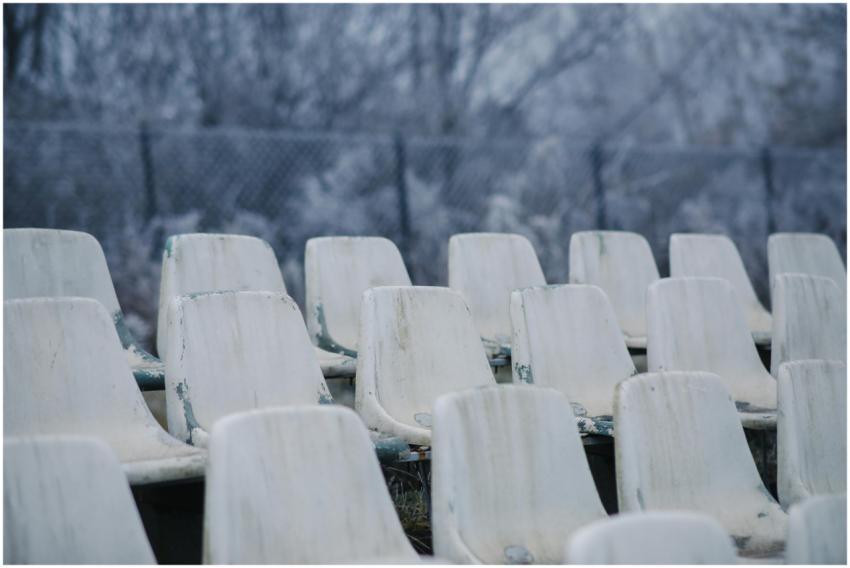 Desolate outdoor plastic seats covered with frost