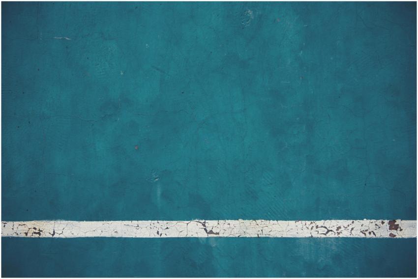 Close-up view of a textured blue wall with a weath