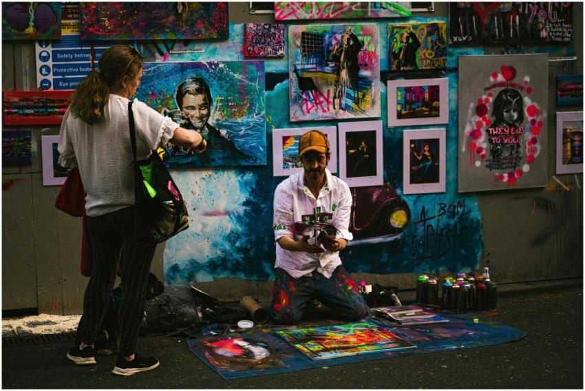 Colorful street art scene with artist and viewer i