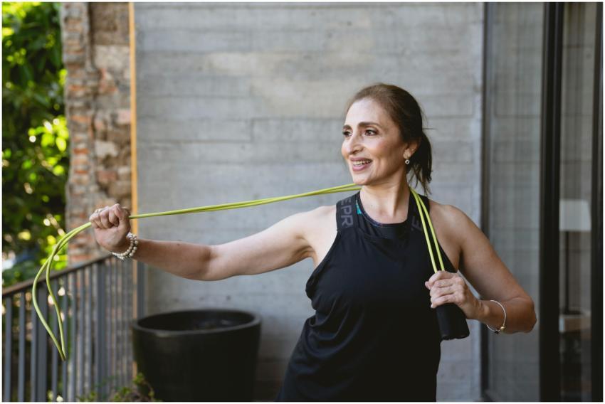 Smiling elderly woman exercising with a jump rope
