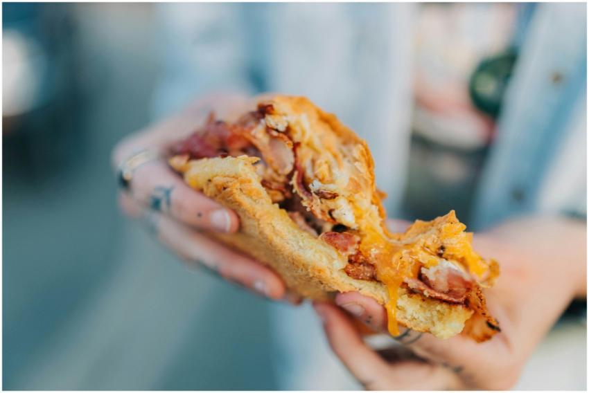 Delicious bacon egg sandwich with melted cheese in