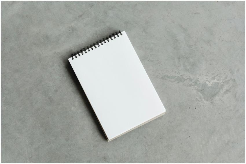 A top view of an open blank spiral notebook on a c