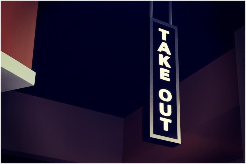 Vertical take out sign hanging indoors in a modern