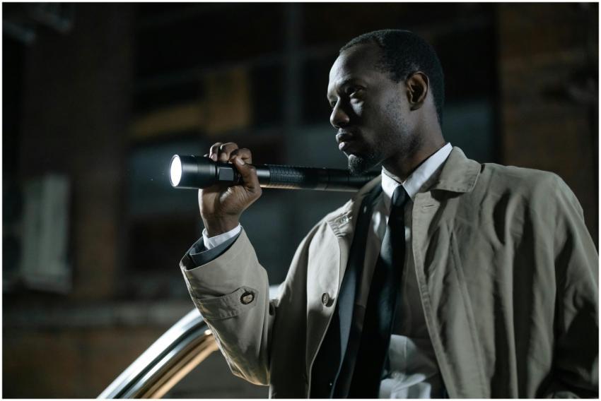 African-American detective in a beige trench coat