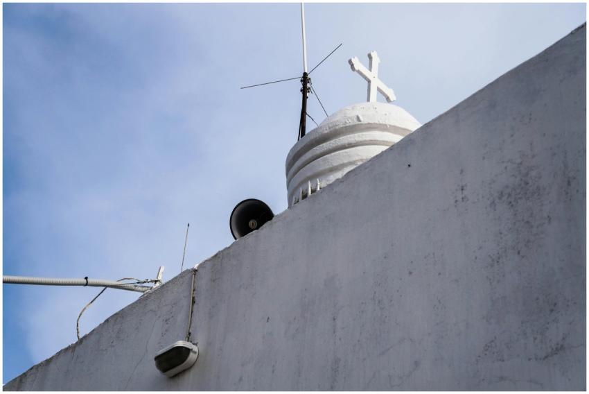 Low angle view of a white church dome with cross a