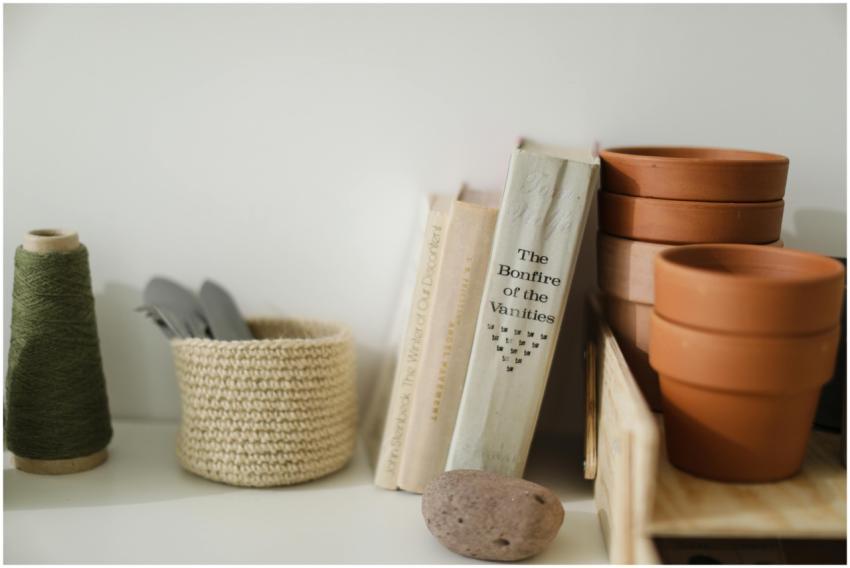 Still life of crafting tools and books on a shelf