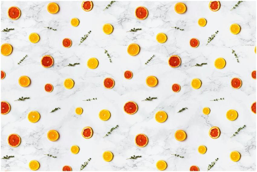 Colorful citrus slices arranged in a flat lay patt