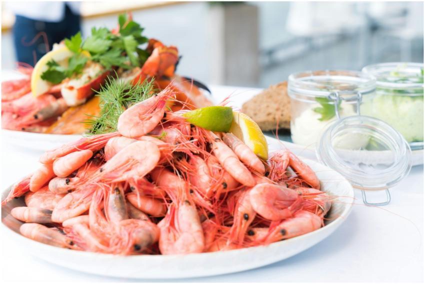 Plate of shrimp and seafood garnished with lemon a