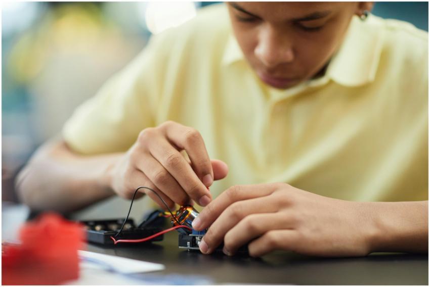 Close-up of a teenager building a robotics project