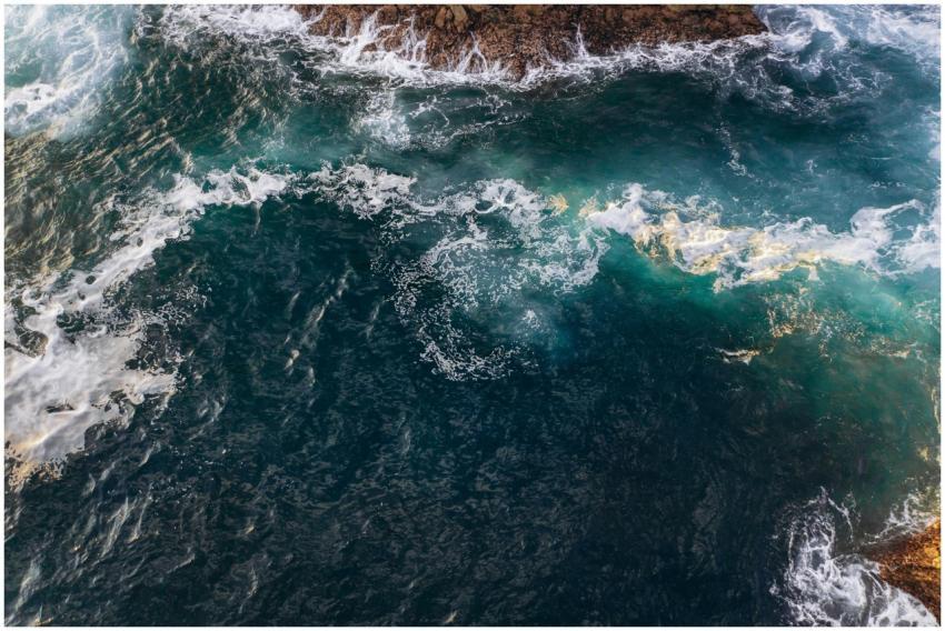 Dramatic aerial shot of ocean waves crashing again