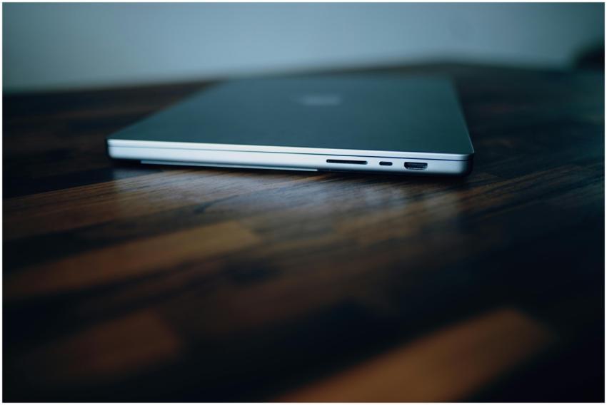 Side view of a closed laptop showing its ports on