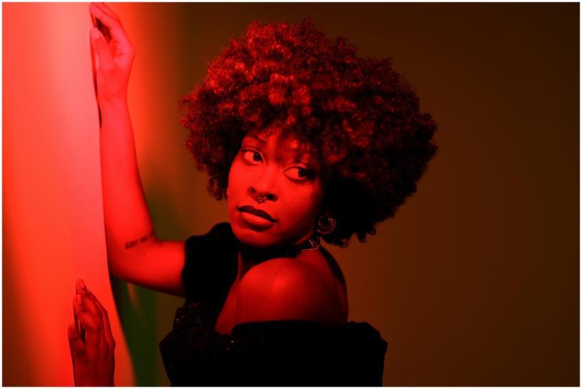 Artistic portrait of a woman in red lighting, show