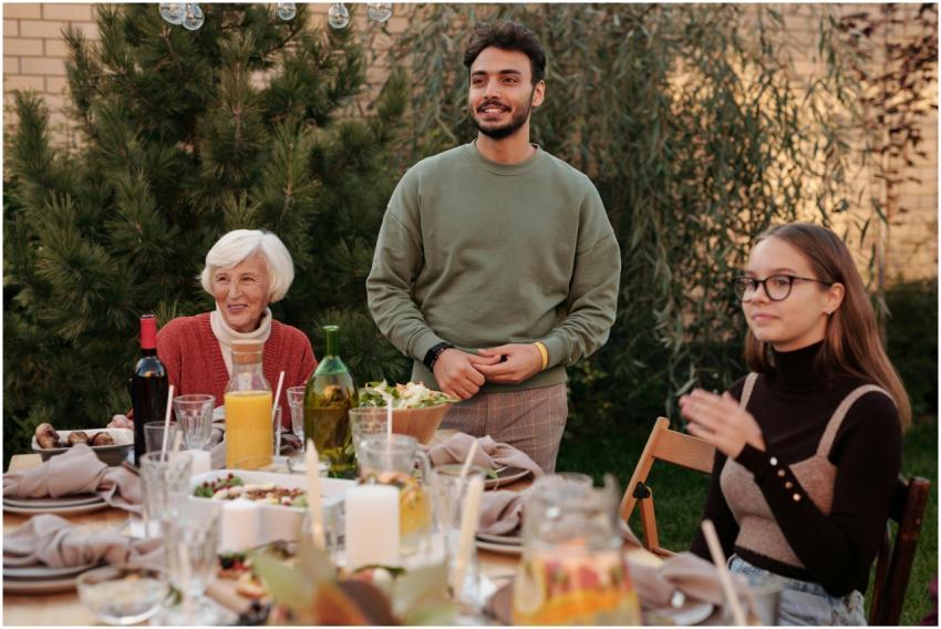 A diverse family enjoying a meal together outdoors