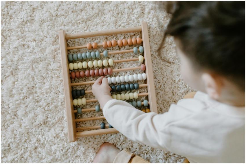 A young child interacting with a colorful wooden a
