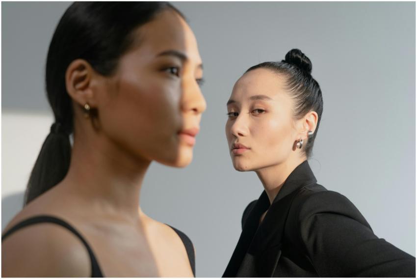 Two stylish Asian women in a studio shoot, showcas