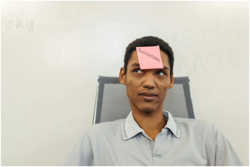 A young businessman with a 'Businessman' note on h