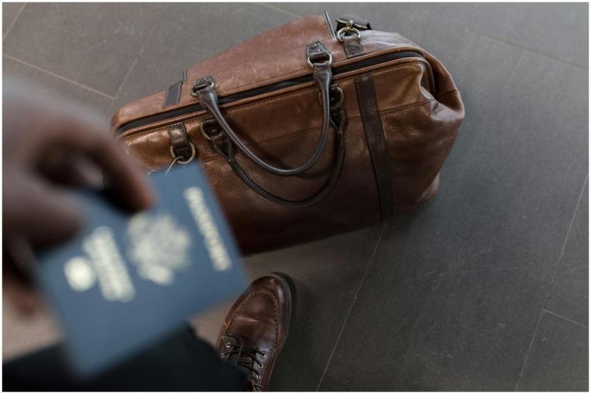 Brown leather bag with passport in an airport sett