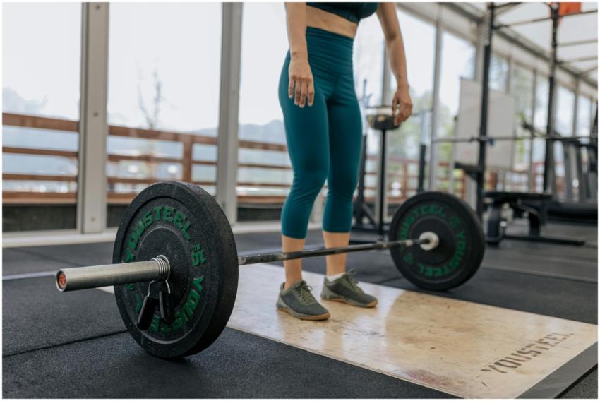 Female athlete preparing to lift a heavy barbell i