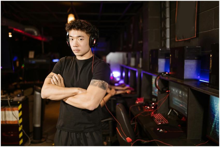 A confident gamer stands in a modern eSports arena